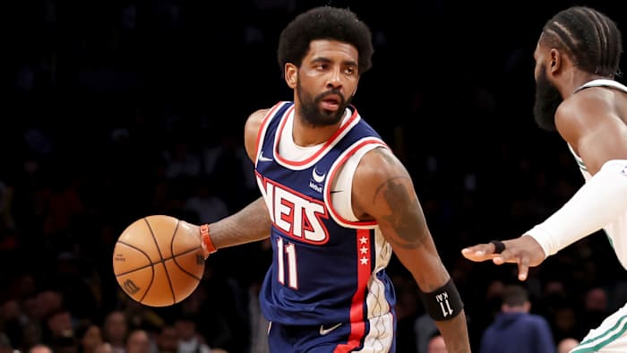 Brooklyn Nets guard Kyrie Irving (11) controls the ball against Boston Celtics guard Jaylen Brown.